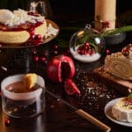 Christmas desserts including a cheesecake and yule log